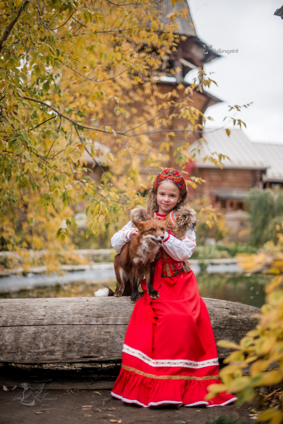 Девочка в платье в русском стиле с лисичкой у пруда
